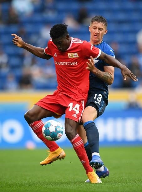 Taiwo Awoniyi of 1.FC Union Berlin is challenged by Angelo Stiller of TSG 1899 Hoffenheim during the Bundesliga match between TSG Hoffenheim and 1....
