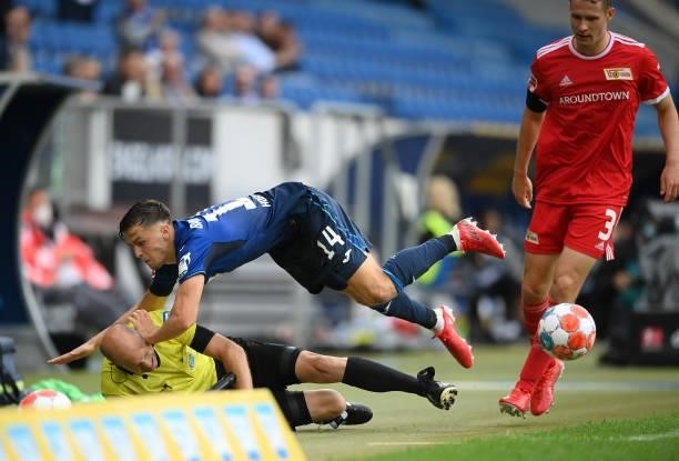 Christoph Baumgartner of TSG 1899 Hoffenheim collides with Assistant Referee, Mike Pickel during the Bundesliga match between TSG Hoffenheim and 1....