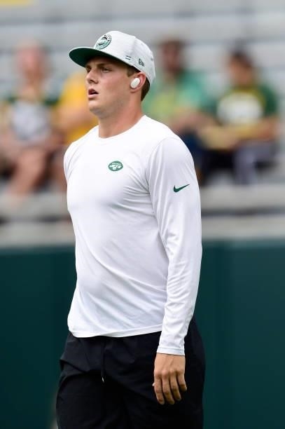 Zach Wilson of the New York Jets warms up before a preseason game against the Green Bay Packers at Lambeau Field on August 21, 2021 in Green Bay,...