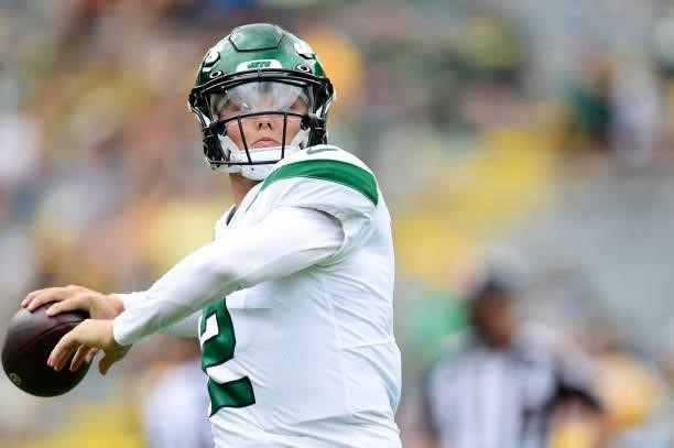 Zach Wilson of the New York Jets throws a pass before a preseason game against the Green Bay Packers at Lambeau Field on August 21, 2021 in Green...