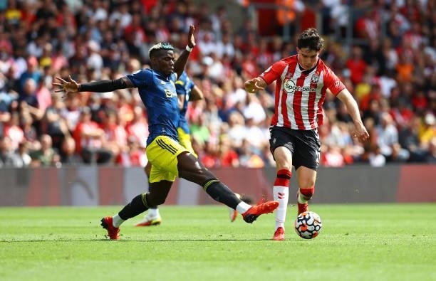 Tino Livramento of Southampton and Paul Pogba of Manchester United during the Premier League match between Southampton and Manchester United at St...