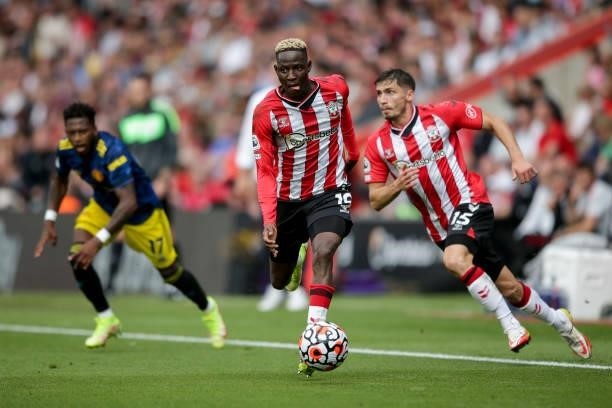 Moussa Djenepo and Romain Perraud of Southampton during the Premier League match between Southampton and Manchester United at St Mary's Stadium on...