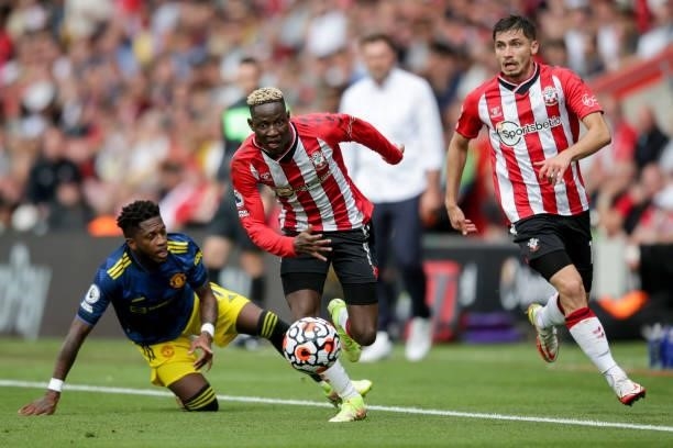 Moussa Djenepo and Romain Perraud of Southampton with Fred of Manchester United during the Premier League match between Southampton and Manchester...