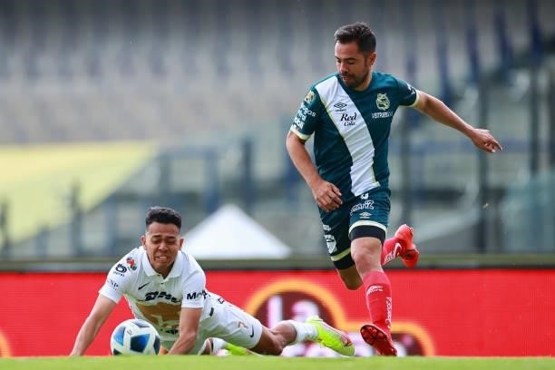 Sebastian Saucedo of Pumas UNAM battles for possesion with George Corral of Puebla during the 6th round match between Pumas UNAM and Puebla as part...