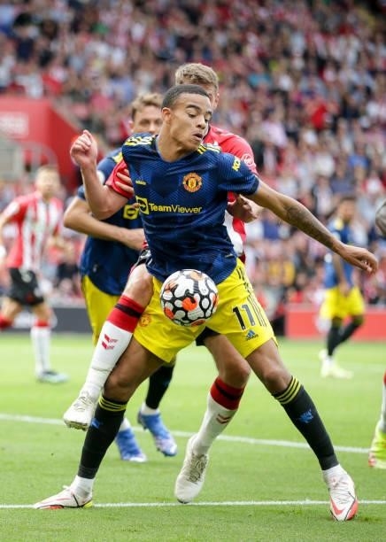 Mason Greenwood of Manchester United holds off Jack Stephens of Southampton during the Premier League match between Southampton and Manchester United...