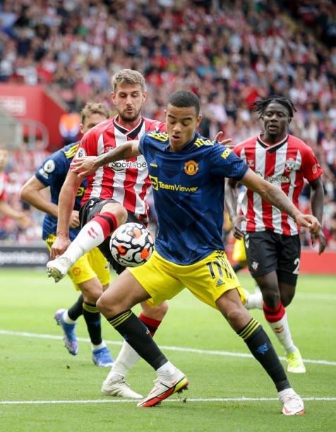 Mason Greenwood of Manchester United holds off Jack Stephens of Southampton during the Premier League match between Southampton and Manchester United...