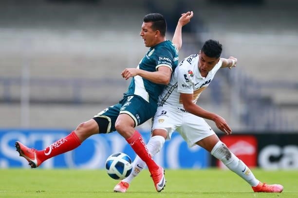 Daniel Alvarez of Puebla battles for possesion with Leonel Lopez of Pumas UNAM during the 6th round match between Pumas UNAM and Puebla as part of...
