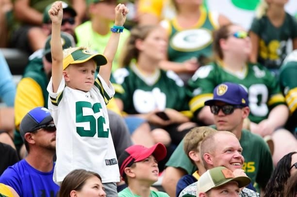 Young Green Bay Packers fan cheers against the New York Jets in the first half of a preseason game at Lambeau Field on August 21, 2021 in Green Bay,...