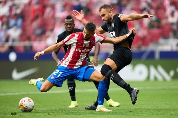 Yannick Carrasco of Club Atletico de Madrid battle for the ball with Gonzalo Verdu of Elche CF during the La Liga Santander match between Club...