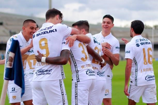 Washington Bryan Corozo of Pumas celebrates with teammates after scoring his team's first goal during the 6th round match between Pumas UNAM and...