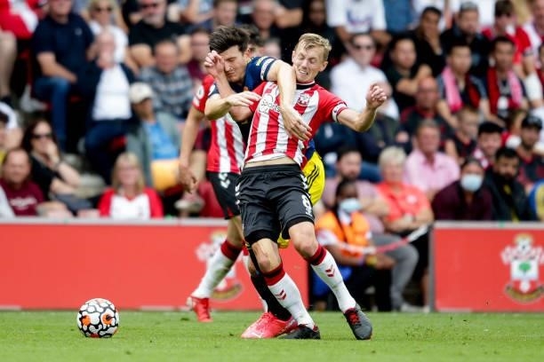 James Ward-Prowse of Southampton holds off Harry Maguire of Manchester United during the Premier League match between Southampton and Manchester...