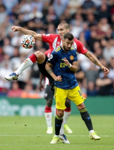 Oriol Romeu of Southampton clears from Bruno Fernandes of Manchester United during the Premier League match between Southampton and Manchester United...