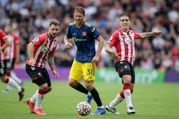 Nemanja Matic of Manchester United clears from Adam Armstrong and Oriol Romeu of Southampton during the Premier League match between Southampton and...