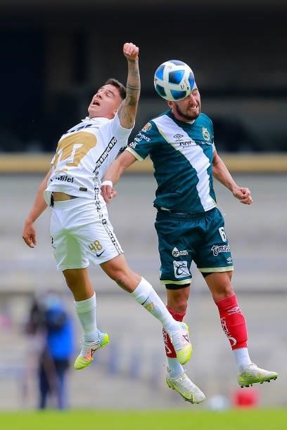 Marco Garcia of Pumas fights for the ball with Javier Salas of Puebla during the 6th round match between Pumas UNAM and Puebla as part of the Torneo...