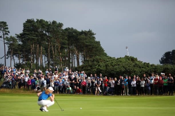 Spectators look on as Louise Duncan of Scotland lines up a putt during Day Four of the AIG Women's Open at Carnoustie Golf Links on August 22, 2021...
