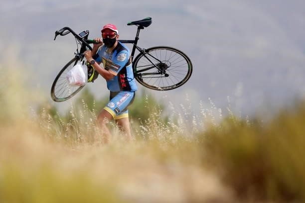 Spectators carries his bicycle on his shoulders in Alto de Velefique during the 76th Tour of Spain 2021, Stage 9 a 188 km stage from Puerto Lumbreras...