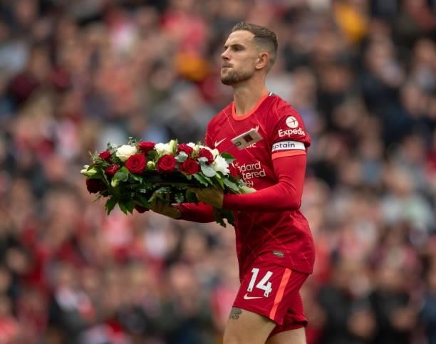 Liverpool captain Jordan Henderson lays a wreath in remembrance of all Liverpool supporters who have passed before the Premier League match between...