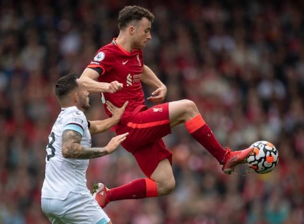 Diogo Jota of Liverpool and Josh Brownhill of Burnley in action during the Premier League match between Liverpool and Burnley at Anfield on August...