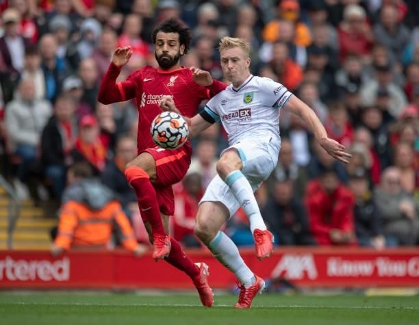Ben Mee of Burnley and Mohamed Salah of Liverpool in action during the Premier League match between Liverpool and Burnley at Anfield on August 21,...