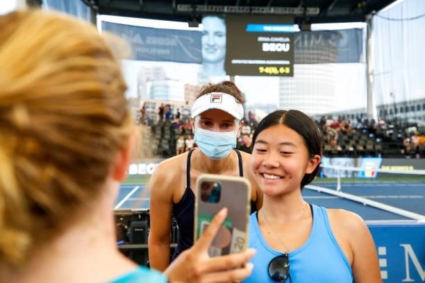 Irina-Camelia Begu of Romania takes selfies with fans after winning the first set against Ekaterina Alexandrova of Russia during their match at...