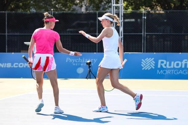 Vera Zvonareva of Russia high-fives Ekaterina Alexandrova of Russia during their doubles match against Julia Lohoff of Germany and Renata Voráová of...