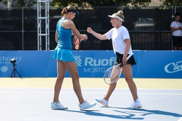 Renata Voráová of Czechia fist bumps Julia Lohoff of Germany during their doubles match against Ekaterina Alexandrova of Russia and Vera Zvonareva of...