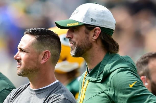 Head coach Matt LaFleur of the Green Bay Packers talks with Aaron Rodgers during warmups before a preseason game against the New York Jets at Lambeau...