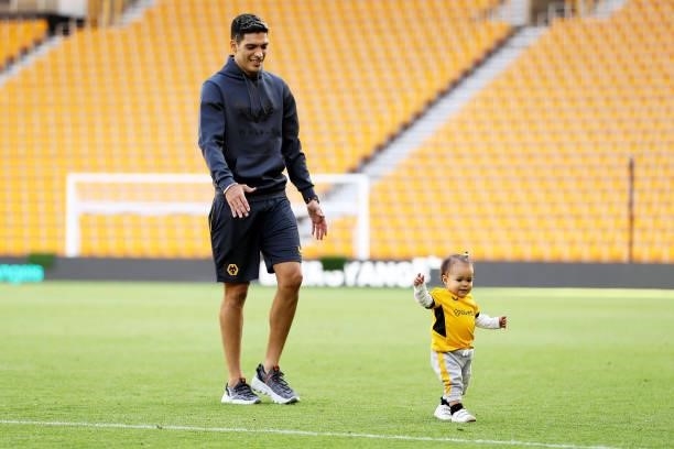 Raul Jimenez of Wolverhampton Wanderers plays with his daughter Arya on the pitch following the Premier League match between Wolverhampton Wanderers...