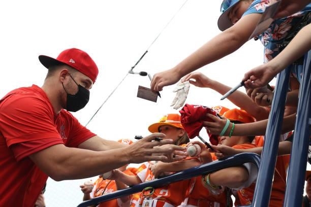 Mike Trout of the Los Angeles Angels signs autographs for fans before playing against the Cleveland Indians in the 2021 Little League Classic at...