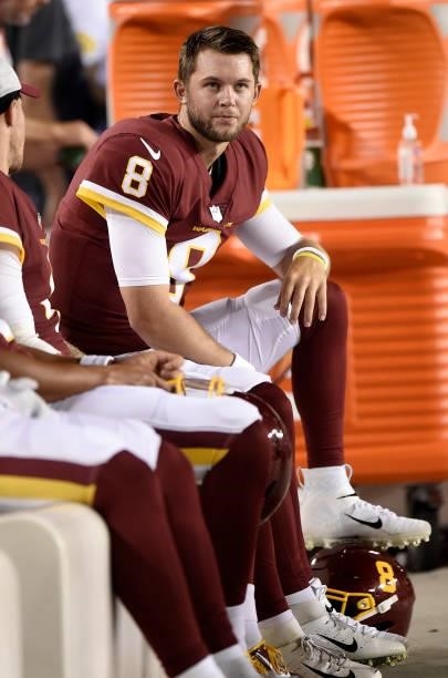 Kyle Allen of the Washington Football Team sits on the bench during the NFL preseason game against the Cincinnati Bengals at FedExField on August 20,...