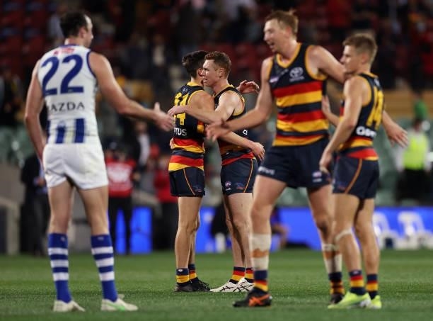Tom Lynch of the Crows and Lachlan Gollant of the Crows celebrate after the siren during the round 23 AFL match between Adelaide Crows and North...