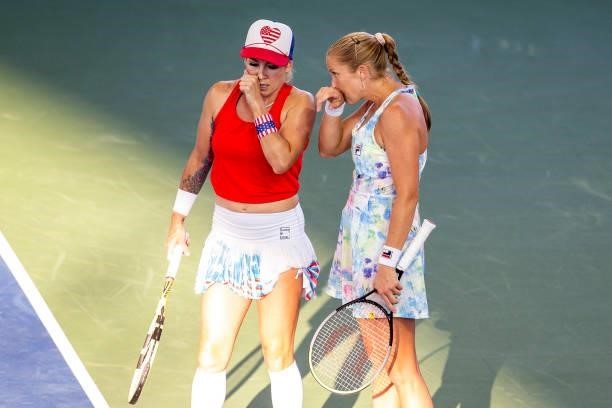 Bethanie Mattek-Sands of USA whispers to Shelby Rogers of USA during their doubles match against Maria Mateas of USA and Yaroslava Shvedova of...