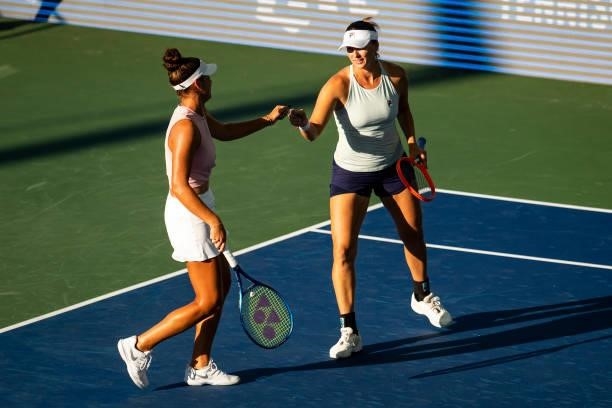 Maria Mateas of USA and Yaroslava Shvedova of Kazakhstan fist bump during their match against Bethanie Mattek-Sands of USA and Shelby Rogers of USA...