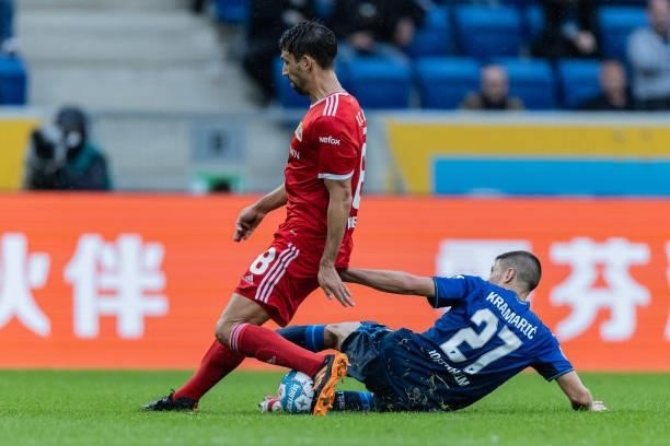 Rani Khedira of Union Berlin is challenged by Andrej Kramaric of Hoffenheim during the Bundesliga match between TSG Hoffenheim and 1. FC Union Berlin...