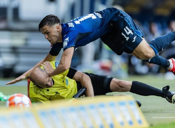 Christoph Baumgartner of Hoffenheim crashes with assistant referee Mike Pickel during the Bundesliga match between TSG Hoffenheim and 1. FC Union...