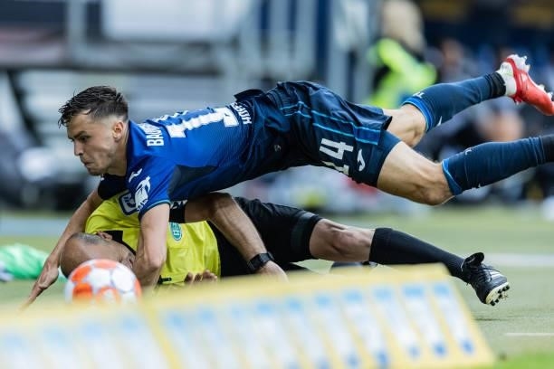 Christoph Baumgartner of Hoffenheim crashes with assistant referee Mike Pickel during the Bundesliga match between TSG Hoffenheim and 1. FC Union...