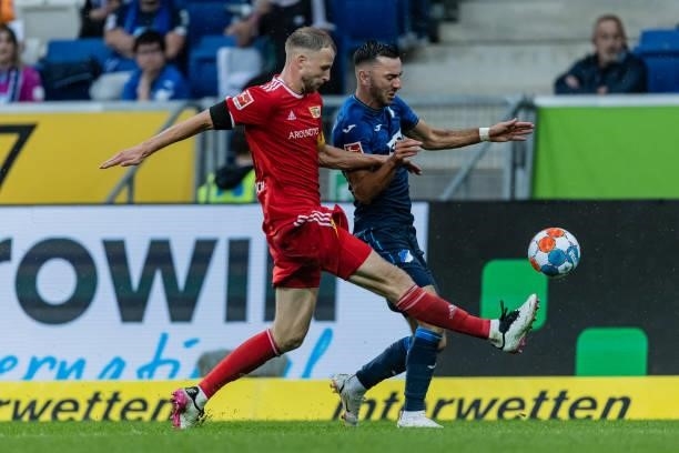 Sargis Adamyan of Hoffenheim is challenged by Marvin Friedrich of Union Berlin during the Bundesliga match between TSG Hoffenheim and 1. FC Union...