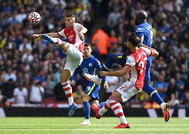 Granit Xhaka of Arsenal jumps for the ball during the Premier League match between Arsenal and Chelsea at Emirates Stadium on August 22, 2021 in...