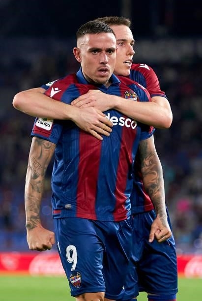 Roger Marti of Levante UD celebrates after scoring his team's first goal with his teammate Carlos Clerc during the La Liga Santander match between...