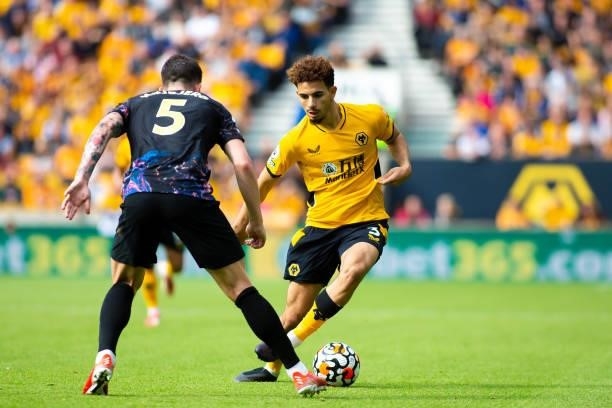 Rayan Ait-Nouri of Wolverhampton Wanderers runs with the ball under pressure from Pierre-Emile Hojbjerg of Tottenham Hotspur during the Premier...