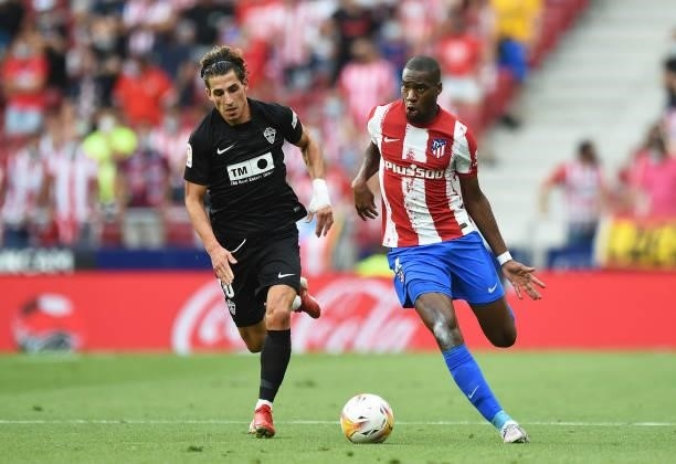 Geoffrey Kondogbia of Atletico de Madrid controls the ball while fending off Rober Correa of Elche CF during the La Liga Santander match between Club...