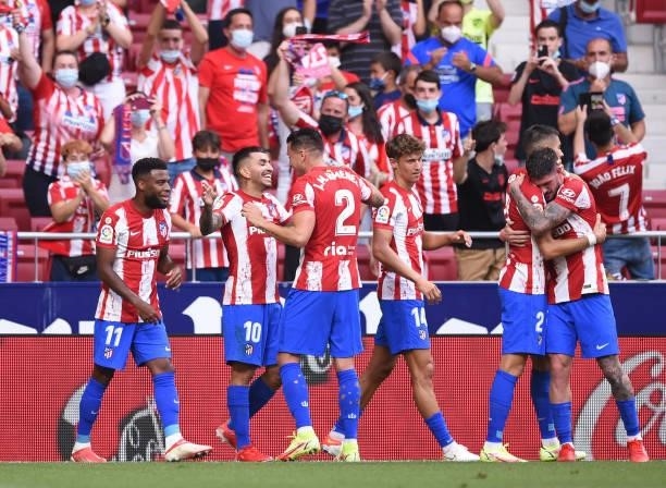 Angel Correa of Atletico de Madrid celebrates with teammates after scoring their opening goal during the La Liga Santander match between Club...
