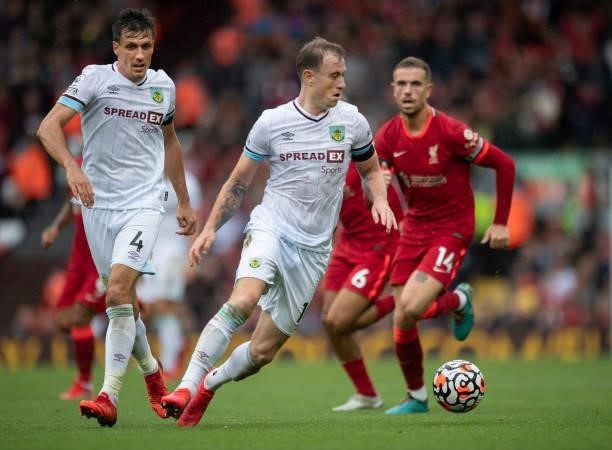 Ashley Barnes of Burnley in action with team mate Jack Cork and Jordan Henderson of Liverpool during the Premier League match between Liverpool and...