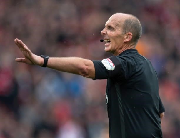 Referee Mike Dean during the Premier League match between Liverpool and Burnley at Anfield on August 21, 2021 in Liverpool, England.