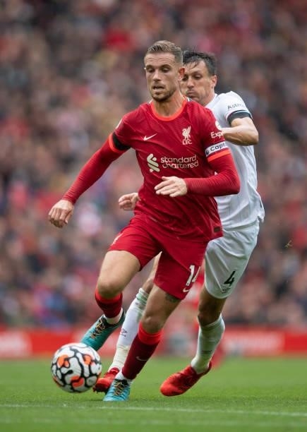 Jordan Henderson of Liverpool and Jack Cork of Burnley in action during the Premier League match between Liverpool and Burnley at Anfield on August...
