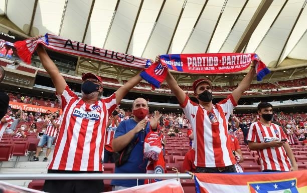 Atletico Madrid fans, wearing face masks show their support during the La Liga Santander match between Club Atletico de Madrid and Elche CF at...