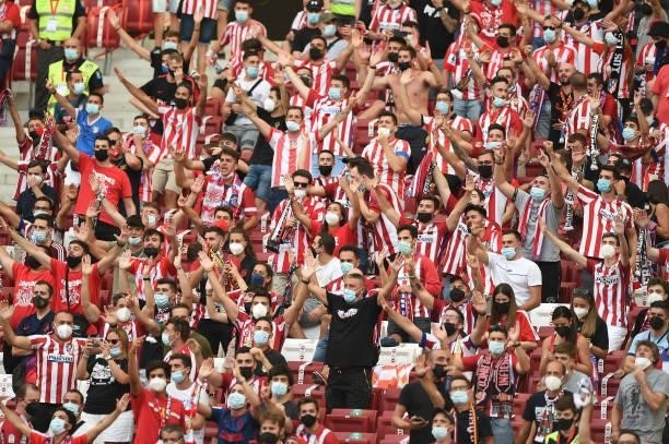 Atletico Madrid fans, wearing face masks show their support prior to the La Liga Santander match between Club Atletico de Madrid and Elche CF at...
