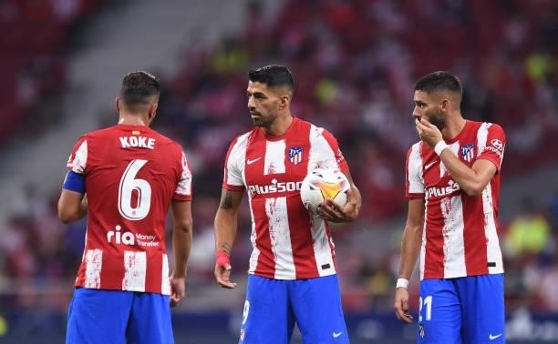 Luis Suarez of Atletico de Madrid reacts with teammates Koke and Yannick Carrasco during the La Liga Santader match between Club Atletico de Madrid...