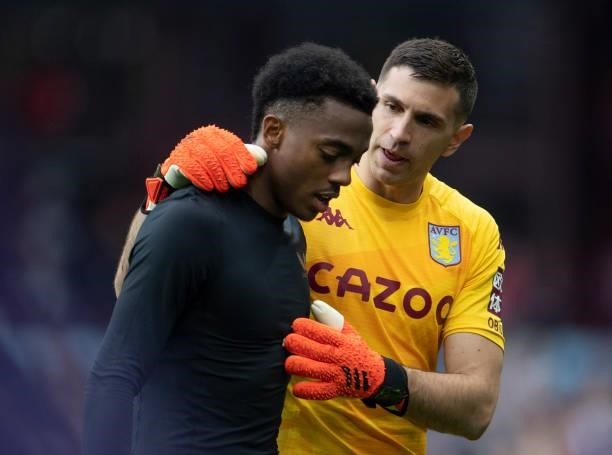 Emiliano Martínez of Aston Villa consoles former Arsenal team mate Joe Willock of Newcastle United after winning the Premier League match between...