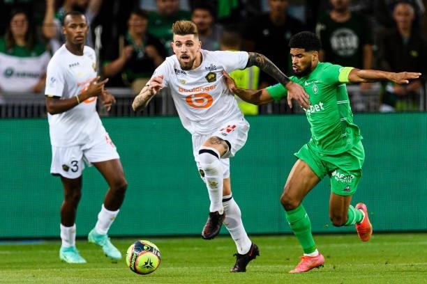 Miguel da Silva Xeka of Lille dribbles Mahdi Camara of Saint-Étienne during the Ligue 1 Uber Eats match between Saint Etienne and Lille at Stade...